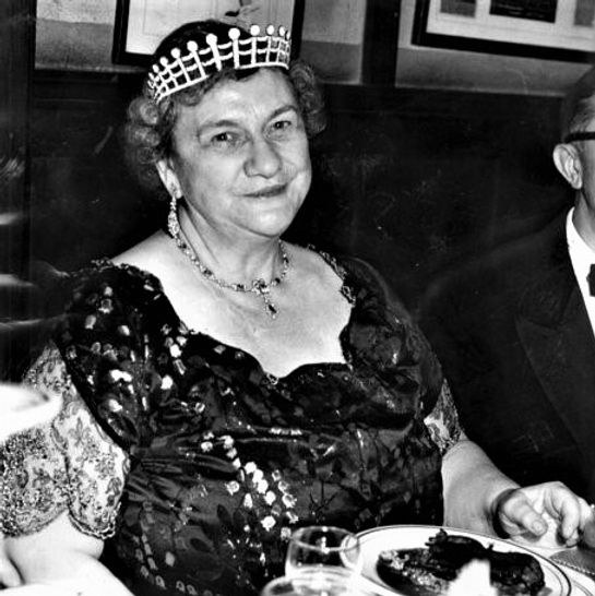 a black and white photo of a woman wearing a crown